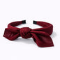 Diadema con lazo en elegante tono burdeos vino tinto